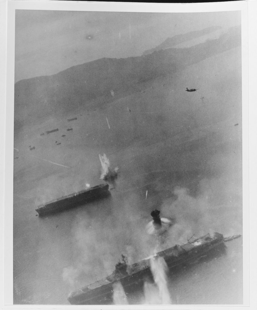 USS Essex (CV-9) planes attack two Japanese aircraft carriers at Kure, 19 March 1945.Ship at bottom is either Amagi or Katsuragi. The other carrier is Kaiyo