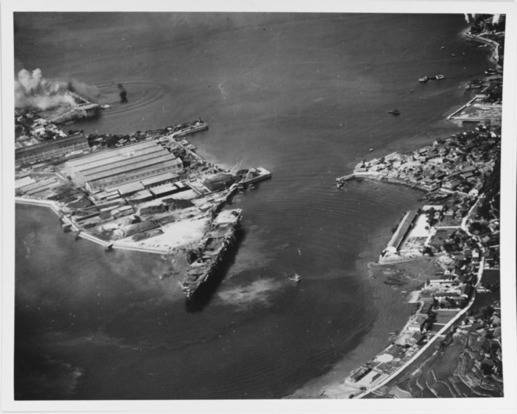 Amagi (centre), burned out, while Katsuragi is attacked by Third Fleet planes