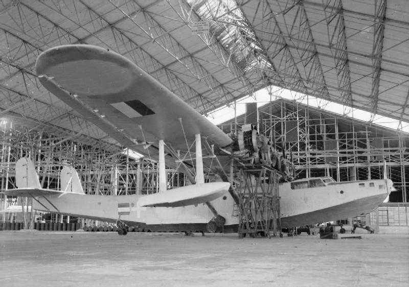 Kawanishi H6K2-L with RAF members checking engines at Sourabaya Java markings added by Indonesian nationalists band of blue added by Dutch